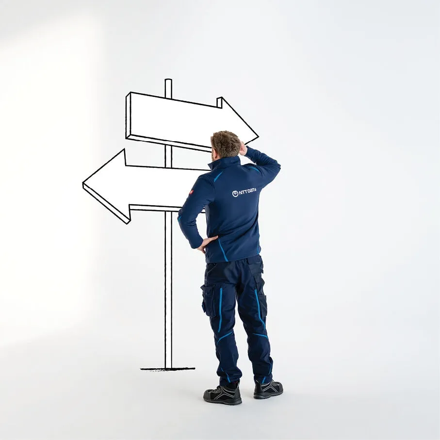 A worker beside a directional signpost
