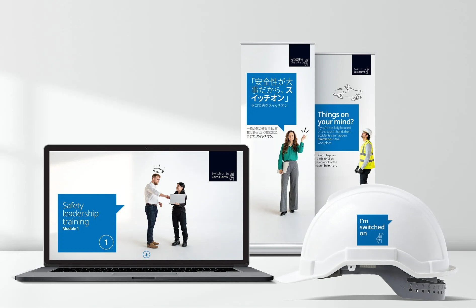 Global data center co behavioural-change campaign assets, including a laptop, posters and a hard hat