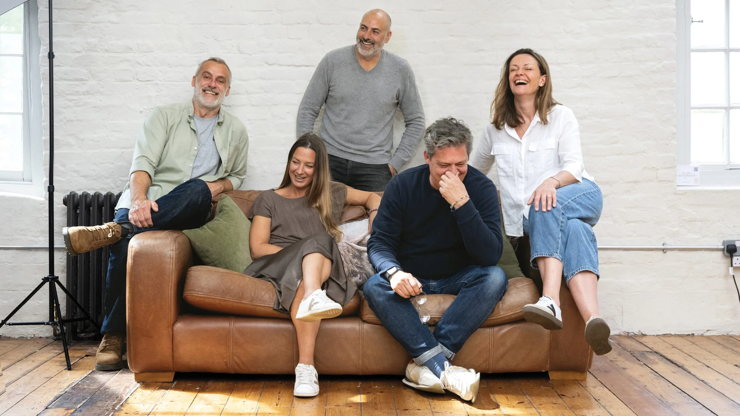 The Curation team gathered on a sofa in their studio